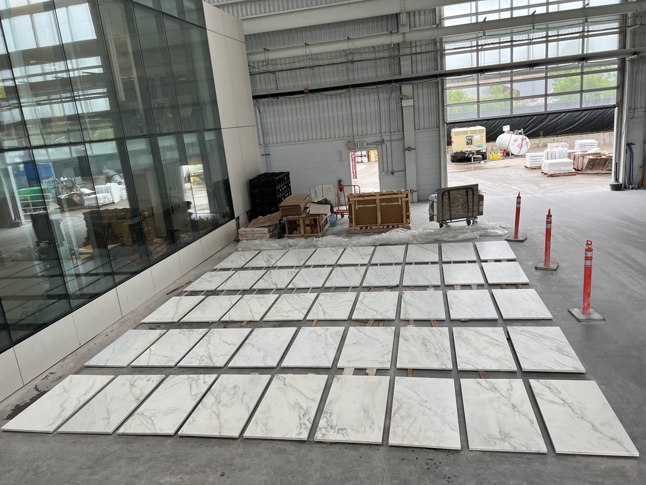 Rows of Alabama White panels laid out on a fabrication shop floor for range and sequencing review